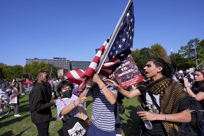 Demonstrators clash with counter protesters over the flag at a rally in Union Park during the Democratic National Convention Wednesday, Aug. 21, 2024, in Chicago. (AP Photo/Alex Brandon)