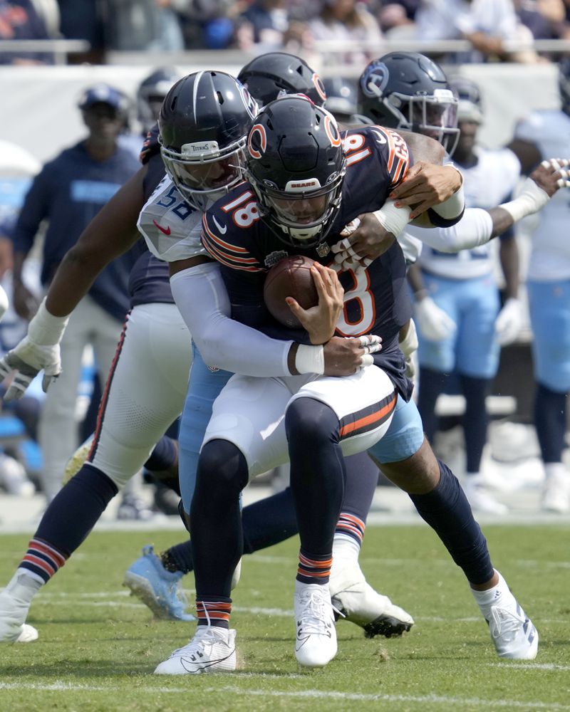 Tennessee Titans linebacker Harold Landry III, left, sacks Chicago Bears quarterback Caleb Williams during the second half of an NFL football game Sunday, Sept. 8, 2024, in Chicago. (AP Photo/Nam Y. Huh)