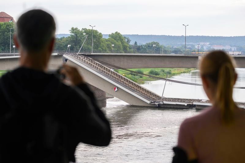 Parts of the Carola Bridge over the Elbe is seen collapsed in Dresden, eastern Germany, Wednesday, Sept. 11, 2024. (Robert Michael/dpa via AP)