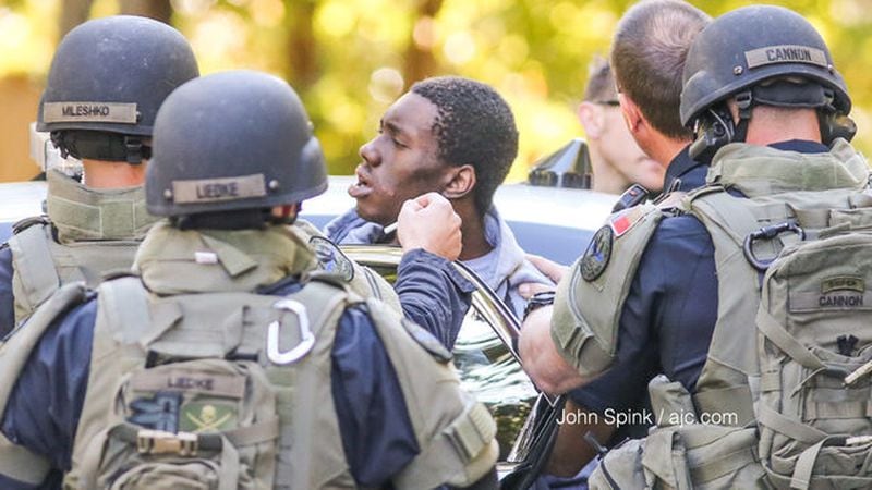 Marietta SWAT officers take Johnson into custody after the standoff. (John Spink/AJC)