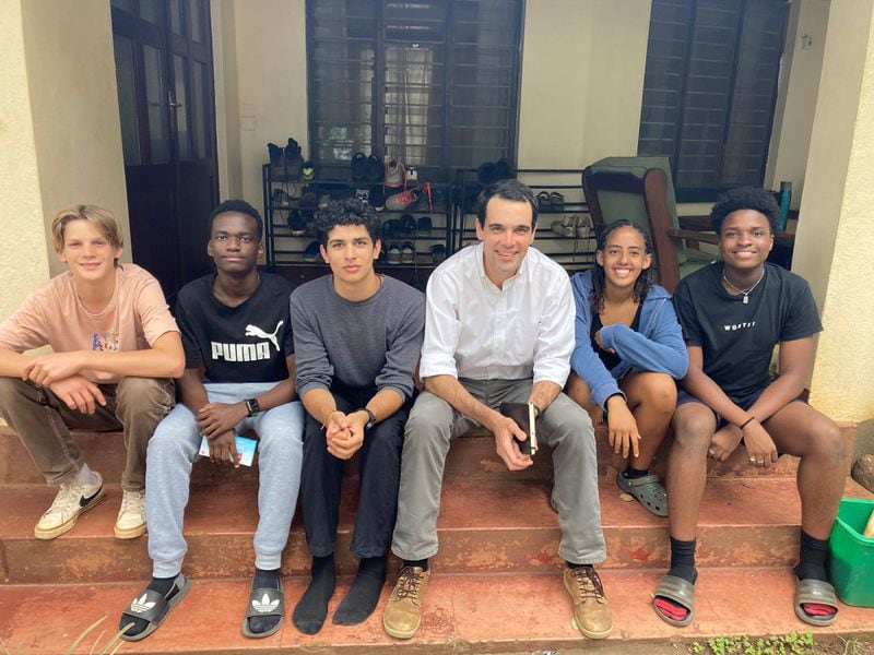 Atlanta native Wade Morris, in white shirt sitting among his students, now in Tanzania. He is the author of a new book, "Report Cards: A Cultural History." Photo contribued.