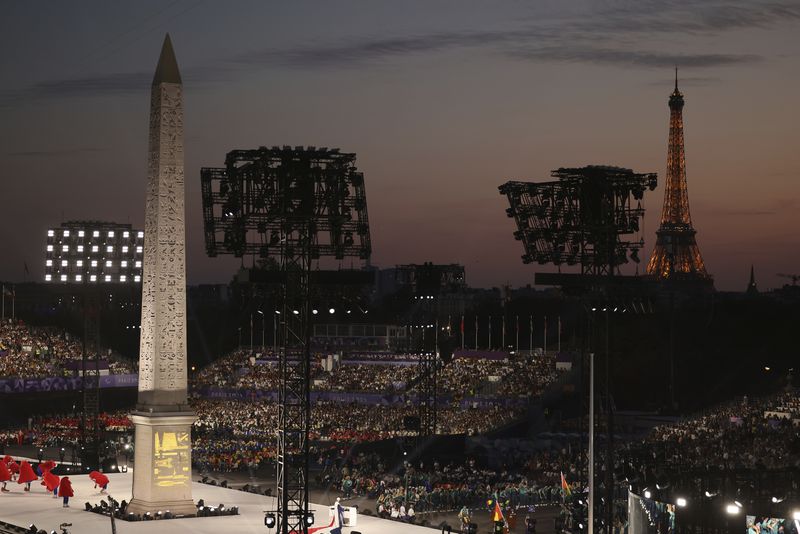 The crowd attends the Opening Ceremony for the 2024 Paralympics, Wednesday, Aug. 28, 2024, on the Concorde plaza in Paris, France. (AP Photo/Thomas Padilla)