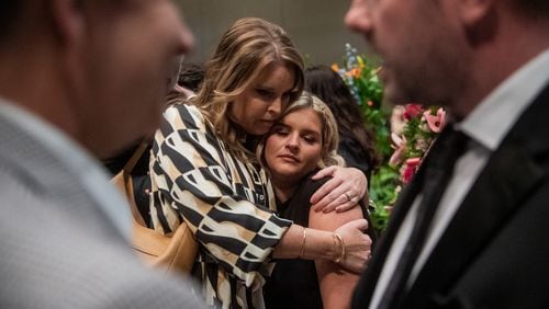 Autumn Nelon gets a hug from a family friend during The Nelons funeral service at Roopville Road Baptist Church in Roopville on Tuesday, Aug. 6, 2024. She was the fourth member of the Atlanta-based gospel group whose three other family members died in a plane crash last month. (Ziyu Julian Zhu / AJC)