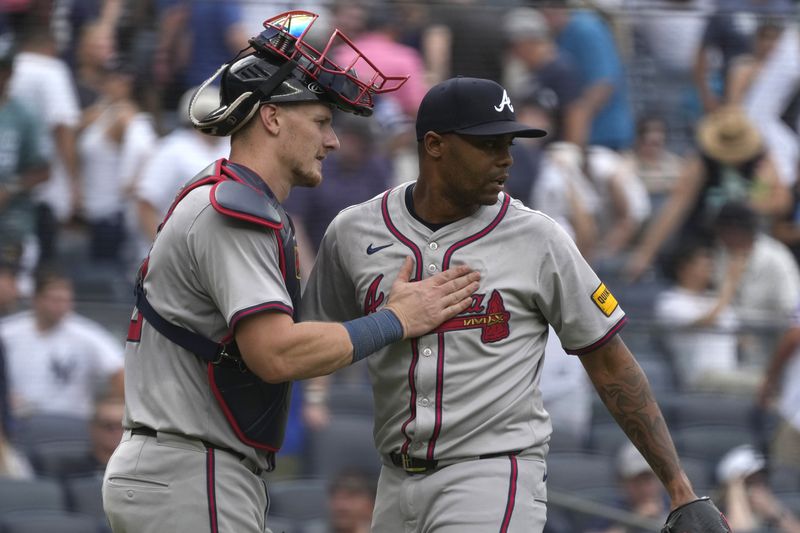 Atlanta Braves catcher Sean Murphy, left, and Raisel Iglesias, right, celebrate after defeating the New York Yankees in a baseball game, Sunday, June 23, 2024, in New York. (AP Photo/Pamela Smith)
