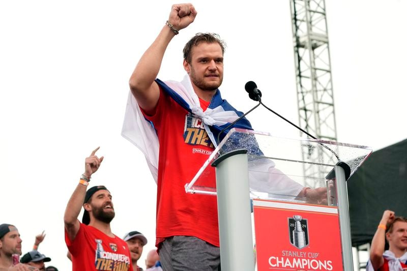 Florida Panthers' Aleksander Barkov, front, gestures while speaking during an NHL hockey rally and parade to celebrate the team's winning of the Stanley Cup, Sunday, June 30, 2024, in Fort Lauderdale, Fla. The Panthers defeated the Edmonton Oilers to win the cup. (AP Photo/Marta Lavandier)