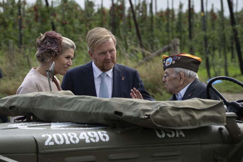 World War II veteran Kenneth Thayer is greeted by Dutch King Willem-Alexander and Queen Maxima before the royals joined Thayer in the jeep during a ceremony marking the 80th anniversary of the liberation of the south of the Netherlands in Mesch, Thursday, Sept. 12, 2024. (AP Photo/Peter Dejong, Pool)