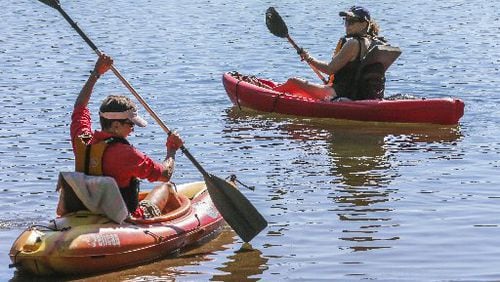 Even on the first day of fall, Carolyn Kohler (right) and Paula Johnson enjoyed the warm weather in September. JOHN SPINK / JSPINK@AJC.COM