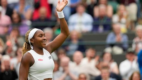 Coco Gauff of the United States waves after defeating Anca Todoni of Romania in their match on day three at the Wimbledon tennis championships in London, Wednesday, July 3, 2024. (AP Photo/Mosa'ab Elshamy)