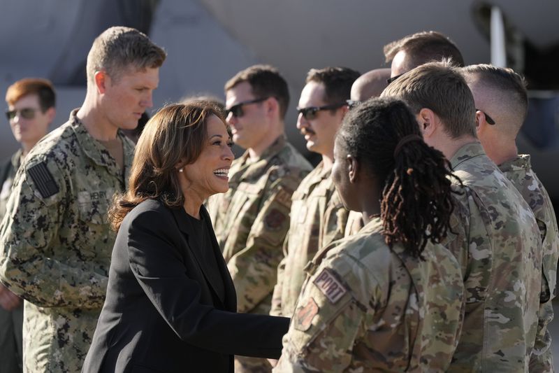 Democratic presidential nominee Vice President Kamala Harris greets members of the military near a C-17 cargo plane after receiving a briefing on the damage from Hurricane Helene, Saturday, October 5, 2024, at the North Carolina Air National Guard in Charlotte, N.C. (AP Photo/Chris Carlson)