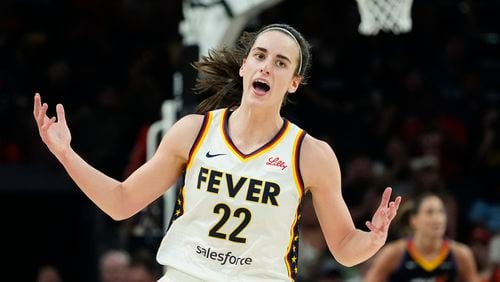 Indiana Fever guard Caitlin Clark celebrates after making a 3-point basket against the Phoenix Mercury during the second half of a WNBA basketball game Sunday, June 30, 2024, in Phoenix. (AP Photo/Ross D. Franklin)
