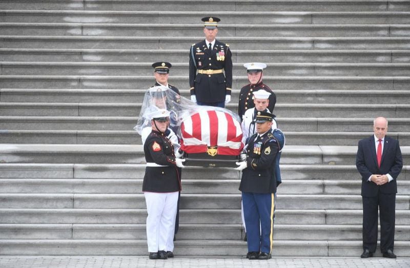 WASHINGTON, DC - SEPTEMBER 1: The casket of Sen. John McCain is carried down the steps of the U.S. Capitol by a military honor guard on September 1, 2018 in Washington, DC. The late senator died August 25 at the age of 81 after a long battle with brain cancer. McCain will be buried at his final resting place at the U.S. Naval Academy.  