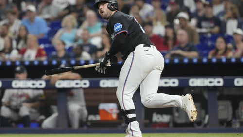 Miami Marlins' Jake Burger (36) hits a single to left field during the third inning of a baseball game against the Atlanta Braves, Friday, Sept. 20, 2024, in Miami. (AP Photo/Marta Lavandier)