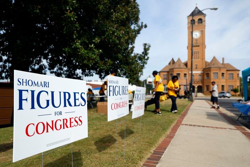 Campaign signs for Alabama's new 2nd Congressional District Democrat Shomari Figures decorate the lawn during the Macon County Day Festival in Tuskegee, Ala., on Saturday, Aug 31, 2024. (AP Photo/ Butch Dill)