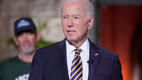 President Joe Biden's speaks with football players at Archmere Academy in Claymont, Del., Friday, Sept. 20, 2024, during a walkthrough visit ahead of his meetings with world leaders there on Saturday. (AP Photo/Mark Schiefelbein)