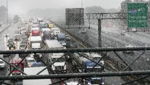 Traffic builds on the I-285 East expressway as a wintery mixture of sleet continues to fall in Metro Atlanta, Friday, December 8, 2017. ALYSSA POINTER/ALYSSA.POINTER@AJC.COM