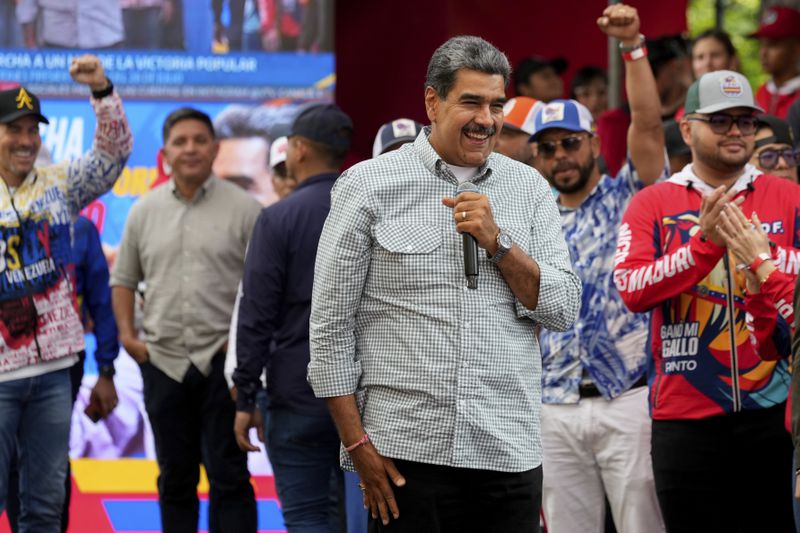 Venezuela's President Nicolas Maduro smiles while addressing government loyalists gathered at the presidential palace in support of his reelection one month after the presidential vote, in Caracas, Venezuela, Wednesday, Aug. 28, 2024. (AP Photo/Ariana Cubillos)