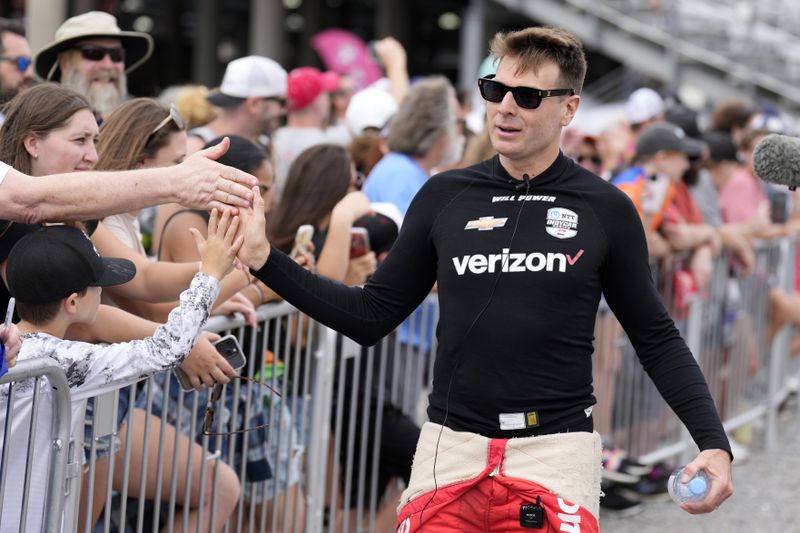 Driver Will Power, right, greets fans before an IndyCar auto race Sunday, Sept. 15, 2024, at Nashville Superspeedway in Lebanon, Tenn. (AP Photo/Mark Humphrey)