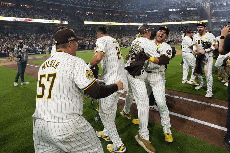 The San Diego Padres celebrate after a win over the Atlanta Braves in Game 2 of an NL Wild Card Series baseball game Wednesday, Oct. 2, 2024, in San Diego. (AP Photo/Gregory Bull)