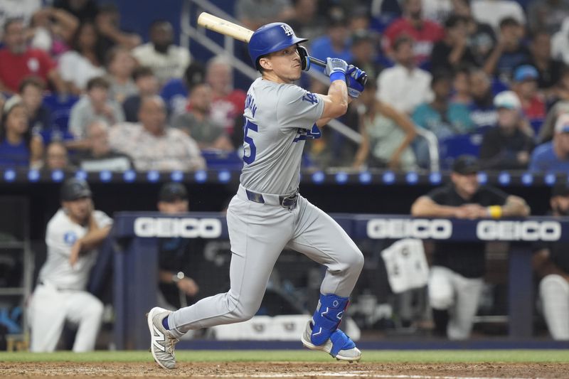 Los Angeles Dodgers' Tommy Edman (25) hits a two-run home run during the fourth inning of a baseball game against the Miami Marlins, Wednesday, Sept. 18, 2024, in Miami. (AP Photo/Marta Lavandier)