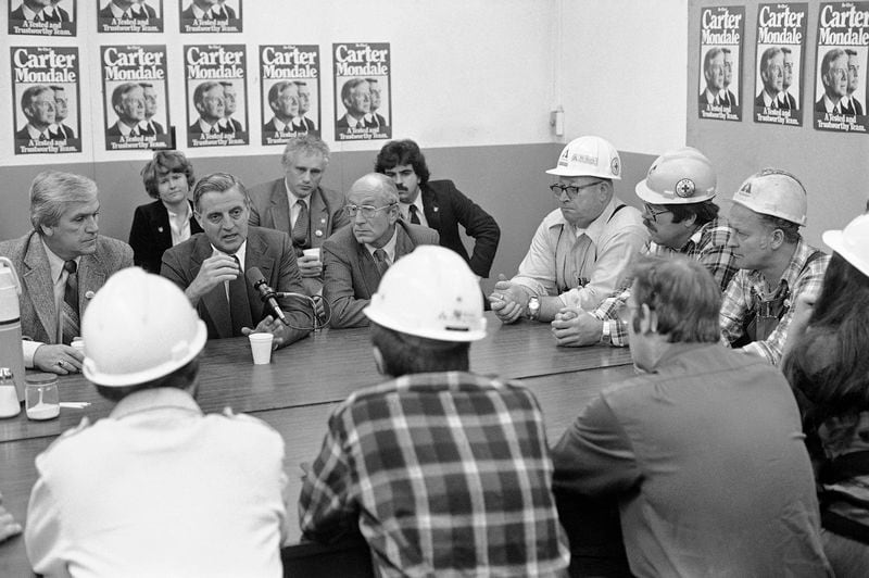 FILE - Then-Vice President Walter Mondale answers a question from a Weyerhaeuser lumber mill employee during a visit on Oct. 27, 1980, in Eugene, Ore., Rep. Jim Weaver, left, and Transportation Secretary Neil Goldschmidt look on. Goldschmidt, a former Oregon governor whose confession that he had sex with a 14-year-old girl in the 1970s blackened what had been a nearly sterling reputation, has died. He was 83. (AP Photo/Jack Smith, File)