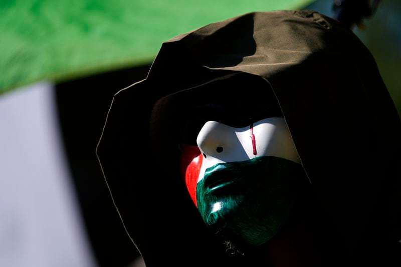 A protester waits at Union Park for the start of a march to the Democratic National Convention Monday, Aug. 19, 2024, in Chicago. (AP Photo/Julio Cortez)