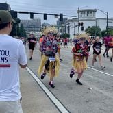 Delta Air Lines employees cheer on runners at the AJC Peachtree Road Race in 2022, part of the airline's decades-long involvement in the race. Courtesy of Delta