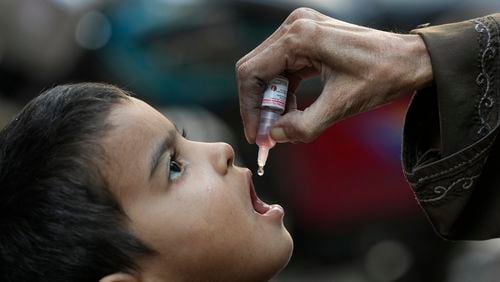 FILE - A health worker administers a polio vaccine to a child in Karachi, Pakistan, Monday, Jan. 8, 2024. (AP Photo/Fareed Khan, File)