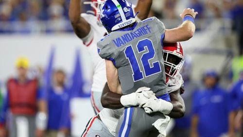 Georgia linebacker Jalon Walker (11) hits Kentucky quarterback Brock Vandagriff (12) on a pass attempt by Vandagriff at Kroger Field, Saturday, Sept. 14, 2024, in Lexington, Kentucky. Walker was called for a defensive penalty on the play. (Jason Getz / AJC)

