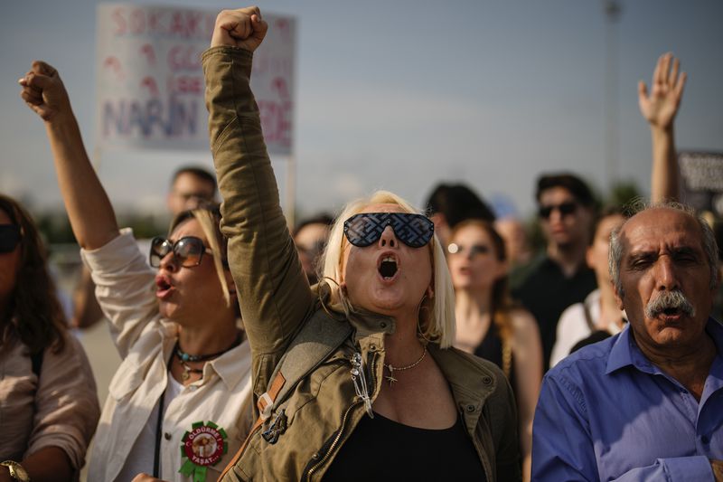 People shout slogans during a protest against a bill approved by Turkish legislators that aims to remove stray dogs off the country's streets, in Istanbul, Turkey, Sunday, Sept. 1, 2024. (AP Photo/Emrah Gurel)