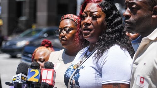 Arnitra Hollman, center, Johnny Hollman’s oldest daughter at a news conference after the family met with Fulton County DA Fani Willis on Tuesday, July 2, 2024.  (Ziyu Julian Zhu / AJC)