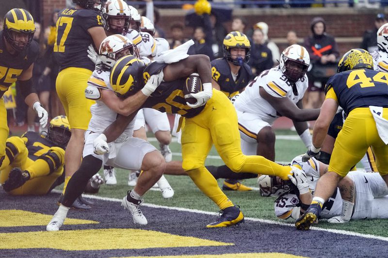 Michigan running back Kalel Mullings (20) rushes for a 1-yard touchdown during the first half of an NCAA college football game against Minnesota, Saturday, Sept. 28, 2024, in Ann Arbor, Mich. (AP Photo/Carlos Osorio)