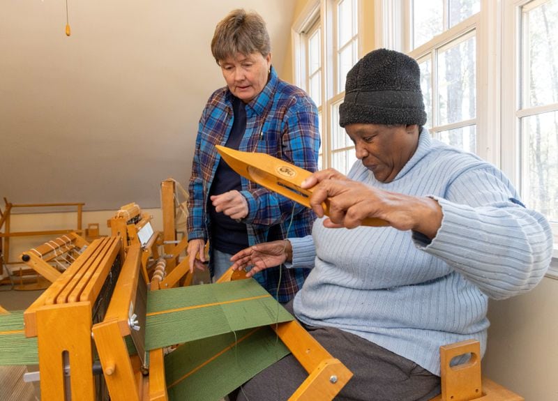 Laura DeMars (left) teaches Rita Walker how to weave. at the Friendship Center of Atlanta.
 PHIL SKINNER FOR THE ATLANTA JOURNAL-CONSTITUTION