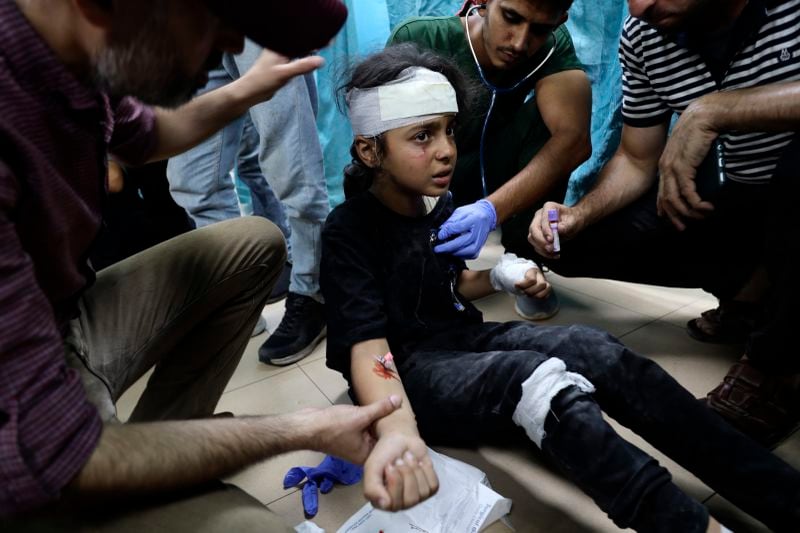 Palestinian medics treat a child wounded youth in the Israeli bombardment on a residential building owned by the Jabr family in the Bureij refugee camp, at al-Aqsa Martyrs Hospital in Deir al Balah, central Gaza Strip, Wednesday, June 12, 2024. (AP Photo/Saher Alghorra)