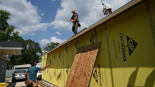 Construction workers continue construction on a Habitat for Humanity project, where local leaders are aiming to boost available of affordable housing, in the 2000 block of Rockspray Court, Wednesday, May 22, 2024, in Hampton. (Hyosub Shin / AJC)