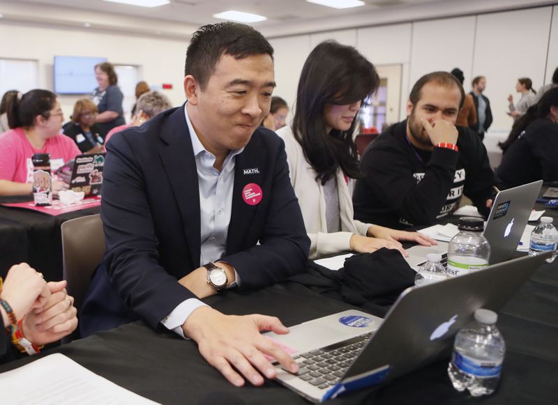November 21, 2019 - Atlanta - Andrew Yang texts folks on his list along with his wife, Evelyn.  Democratic presidential candidates including Cory Booker, Amy Klobuchar, Andrew Yang and Pete Buttigieg, along with Stacey Abrahms,  were calling and texting voters Thursday whose registrations could be canceled in Georgia at a Fair Fight phone bank at Ebenezer Baptist Church in Atlanta. The phone bank was in response to Georgia election officials' plan to cancel more than 313,000 voter registrations next month.   