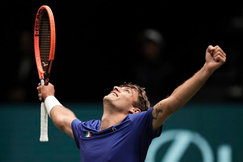 Italy's Flavio Cobolli celebrates beating Netherlands' Tallon Griekspoor during their Davis Cup tennis match, at the Unipol Arena, in Bologna, Italy, Sunday, Sept. 15, 2024. (Massimo Paolone/LaPresse via AP)