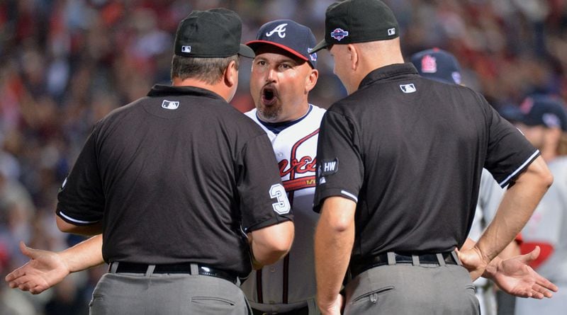 October 5, 2012 Atlanta - Atlanta Braves manager Fredi Gonzalez appeals to umpire Sam Holbrook (left) and umpire Jeff Nelson in the 8th inning of the NL wild-card baseball game at Turner Field in Atlanta on Friday, October 5, 2012. The game was stopped after officials decided Simmons was out on the infield fly rule. I have not seen Braves manager Fredi Gonzalez getting so upset and appealing strongly. Made with Nikon D4, 200-400 mm zoom lens at 400 mm, F4 at 1/1000 second and a ISO speed rating of 4000. HYOSUB SHIN / HSHIN@AJC.COM