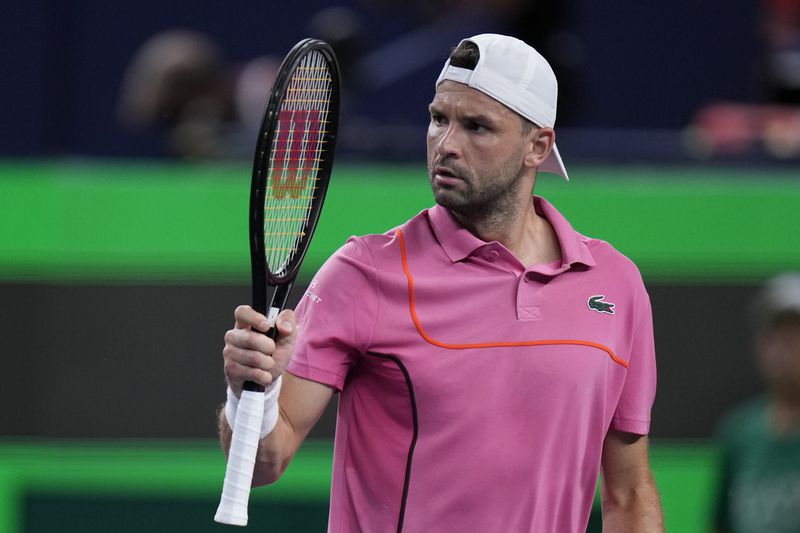 Grigor Dimitrov of Bulgaria reacts during the men's singles second round match against Zizou Bergs of Belgium in the Shanghai Masters tennis tournament at Qizhong Forest Sports City Tennis Center in Shanghai, China, Monday, Oct. 7, 2024. (AP Photo/Andy Wong)