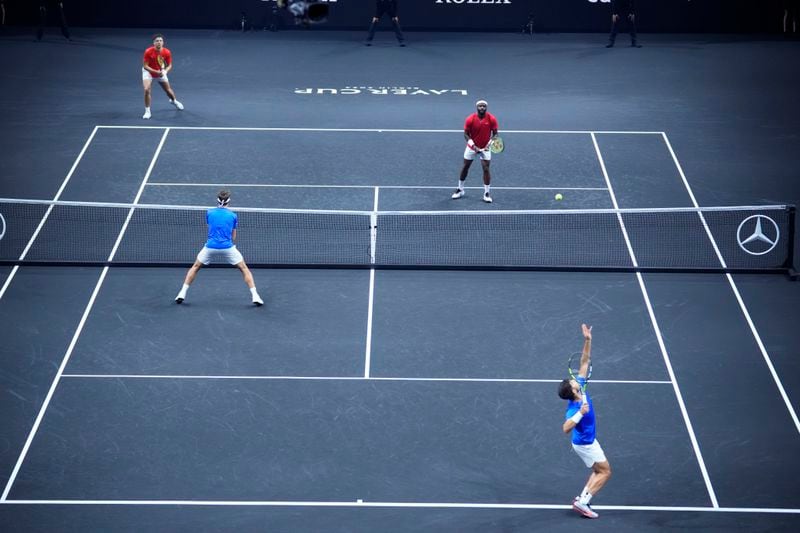 Team Europe's Carlos Alcaraz tosses the ball in the air to serve as he and Casper Ruud play during their doubles match against Team World's Frances Tiafoe and Ben Shelton on the third day of the Laver Cup tennis tournament, at the Uber arena in Berlin, Germany, Sunday, Sept. 22, 2024. (AP Photo/Ebrahim Noroozi)