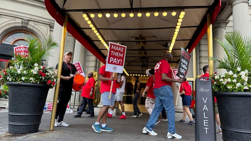 Hotel workers on strike chant and beat drums while picketing outside the Fairmont Copley Plaza hotel on Sunday, Sept. 1, 2024, in Boston. (AP Photo/Rodrique Ngowi)