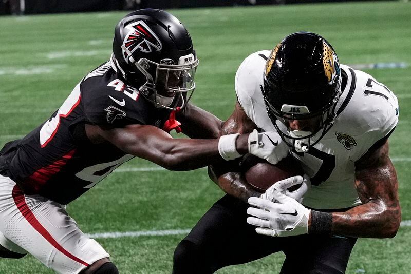 Jacksonville Jaguars tight end Evan Engram (17) makes a touchdown catch against Atlanta Falcons cornerback Anthony Johnson (43) in the first half of an NFL preseason footballl game, Friday, Aug. 23, 2024, in Atlanta. (AP Photo/John Bazemore)