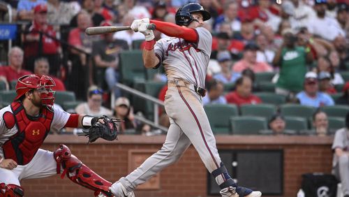 Atlanta Braves' Jarred Kelenic watches his RBI single next to St. Louis Cardinals catcher Pedro Pages during the eighth inning in the second game of a baseball doubleheader Wednesday, June 26, 2024, in St. Louis. (AP Photo/Joe Puetz)