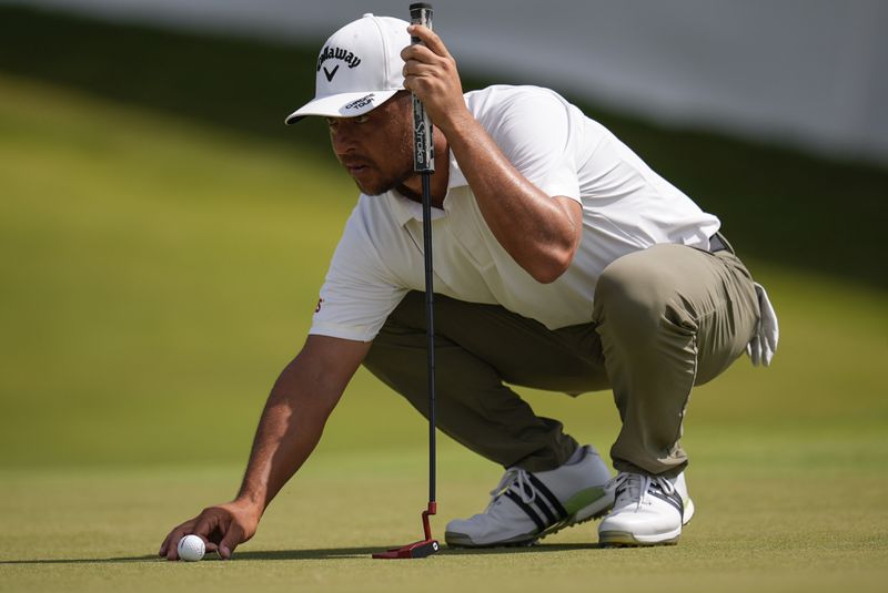 Xander Schauffele lines up his putt on the seventh green during the second round of the Tour Championship golf tournament, Friday, Aug. 30, 2024, in Atlanta. (AP Photo/Mike Stewart)