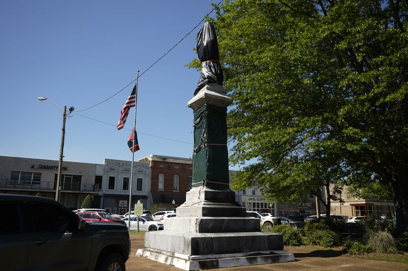 A weather-worn tarp covers the century-old Confederate monument in Grenada, Miss., April 12, 2023. (AP Photo/Rogelio V. Solis)