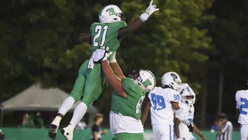 Roswell running back Nick Peal (21) celebrates his rushing touchdown with offensive lineman Kevin Guardado (66) during the second half against Seckinger at Roswell High School, Friday, Sept. 20, 2024, in Roswell, Ga. (Jason Getz / AJC)

