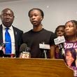 Malachi Hill Massey, 17, center, speaks at a news conference on Tuesday, July 23, 2024, at the NAACP headquarters in Springfield, Ill., about his mother, Sonya Massey, who was shot to death by a Sangamon County Sheriff's deputy on July 6 in Springfield after calling 911 for help. On the left is civil right attorney Ben Crump, who is representing the Massey family. On the right is Sonya Massey's daughter, Jeanette Summer Massey, 15. (AP Photo/John O'Connor)
