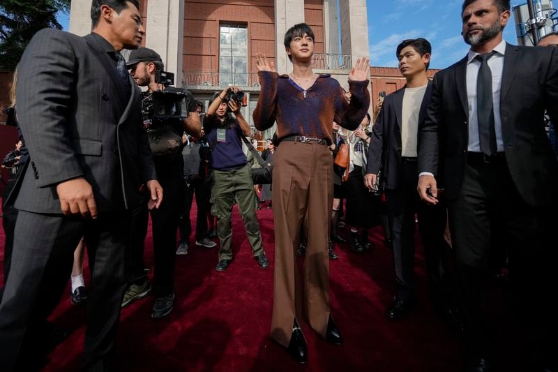 Jin departs the Gucci Spring Summer 2025 collection, that was presented in Milan, Italy, Friday, Sept. 20, 2024. (AP Photo/Luca Bruno).