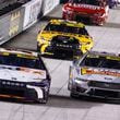 Denny Hamlin (11) leads Chase Briscoe (14) and Christopher Bell (20) during a NASCAR Cup Series auto race, Saturday, Sept. 21, 2024, in Bristol, Tenn. (AP Photo/Wade Payne)