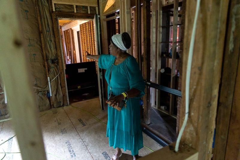 Dorothy Williams, who fell victim to a home repair scam, gives a tour of her gutted home in Atlanta on Monday, May 13, 2024. (Arvin Temkar / AJC)