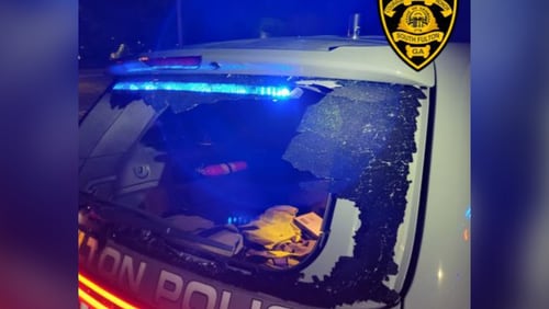 A South Fulton police vehicle was vandalized while the officer was inside during an illegal street racing gathering, authorities said.